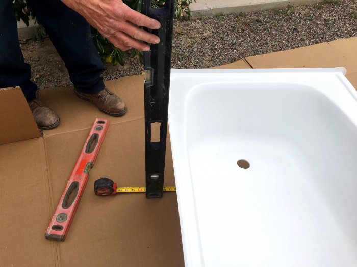 Use a level and tape measure to measure the height of the new tub. (Photo courtesy of Don Paz, Legendary Home Services)
